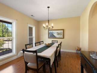 This inviting dining room features a large table set for a meal, perfect for family gatherings.