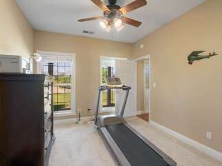 This room offers a dedicated fitness space with a treadmill, perfect for maintaining your workout routine indoors.