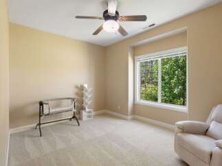 This room features a comfortable recliner and a ceiling fan, perfect for relaxation.