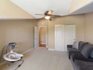 This spacious room features a comfortable gray sectional sofa, perfect for relaxing or entertaining.