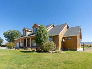 This charming home features a welcoming covered porch and a spacious two-car garage, perfect for vehicles and storage.