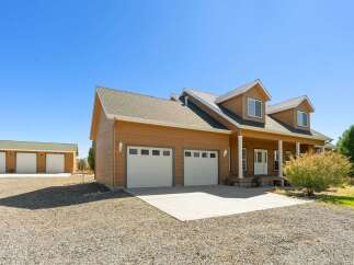 Discover this charming property featuring a spacious main house with a welcoming front porch and attached two-car garage.