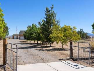 Welcome to this expansive property featuring a spacious home with a large garage, perfect for vehicles and storage.