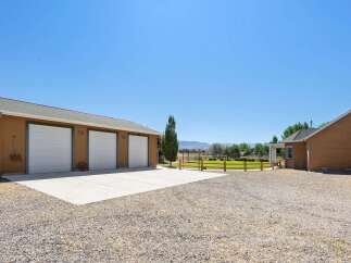 Discover this expansive property featuring a spacious three-car garage, perfect for vehicles and storage.