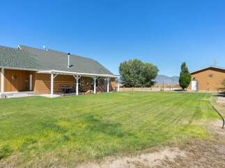 Enjoy the spacious outdoor living with a covered patio perfect for entertaining, complete with a grill and seating area.