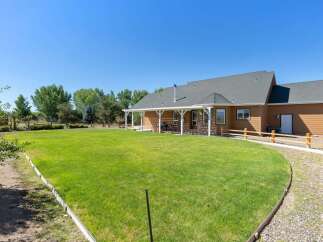 Enjoy spacious outdoor living with a large, manicured lawn perfect for recreation and relaxation.