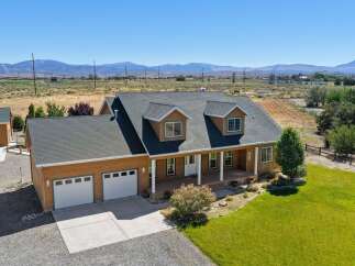 Discover this charming home featuring a spacious front porch perfect for enjoying the scenic mountain views.