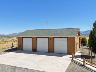 Discover this charming property featuring a spacious three-car garage, perfect for vehicles and storage.
