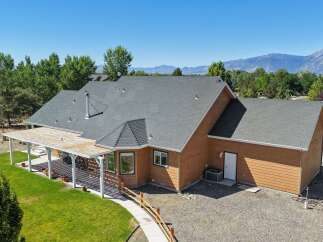 Discover this charming home featuring a spacious covered patio perfect for outdoor entertaining, complemented by a well-maintained lawn and mature trees.