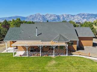 Experience breathtaking mountain views from this stunning property, featuring a spacious home with a large covered patio perfect for outdoor entertaining.