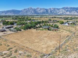 Discover this expansive property offering ample space for your dreams to unfold, set against a backdrop of majestic mountains.