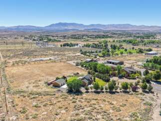 Discover this expansive property featuring a spacious home with a multi-car garage, perfect for car enthusiasts or ample storage needs.