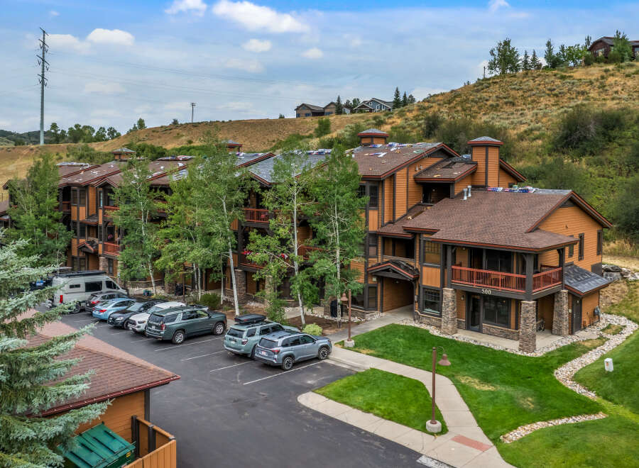 Discover this charming mountain property featuring a multi-story building with attractive wood siding and stone accents.