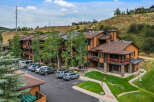 Discover this charming mountain property featuring a multi-story building with attractive wood siding and stone accents.