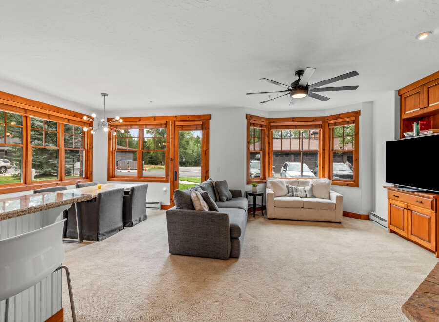Experience comfortable living in this inviting space, featuring a spacious living area with plush seating and a large TV for entertainment.