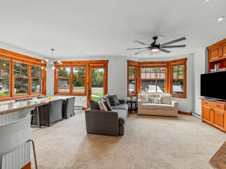 Experience comfortable living in this inviting space, featuring a spacious living area with plush seating and a large TV for entertainment.