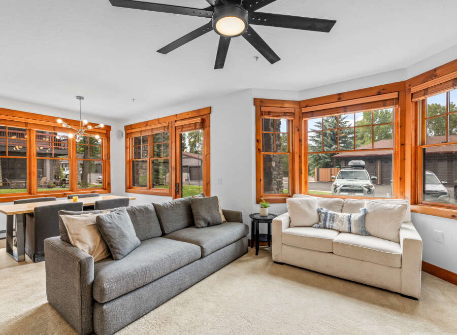 Experience comfortable living in this inviting living and dining area, featuring a spacious sectional sofa and a modern dining set perfect for family meals.