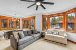 Experience comfortable living in this inviting living and dining area, featuring a spacious sectional sofa and a modern dining set perfect for family meals.