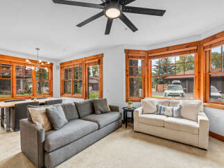 Experience comfortable living in this inviting living and dining area, featuring a spacious sectional sofa and a modern dining set perfect for family meals.