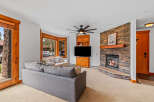 Cozy living room featuring a stone fireplace with a roaring fire, perfect for chilly evenings.