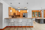This inviting kitchen features warm wood cabinetry and a granite-topped breakfast bar, perfect for casual dining.
