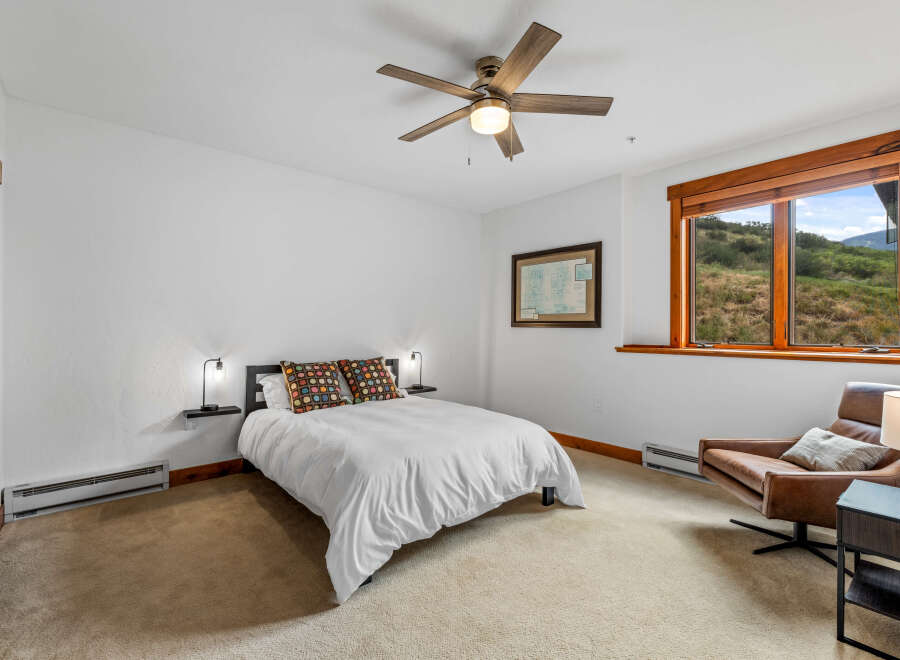 Experience comfort and style in this inviting bedroom, featuring a plush queen-size bed adorned with decorative pillows.