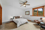 Experience comfort and style in this inviting bedroom, featuring a plush queen-size bed adorned with decorative pillows.