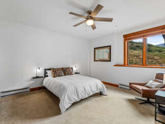 Experience comfort and style in this inviting bedroom, featuring a plush queen-size bed adorned with decorative pillows.