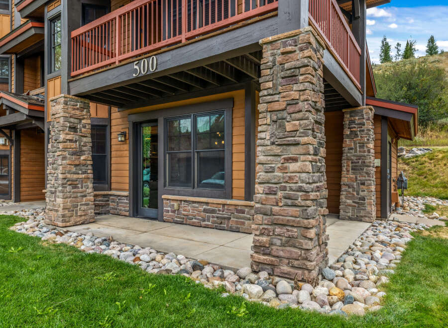 Experience mountain living in this charming property featuring a rustic stone facade and warm wood siding.