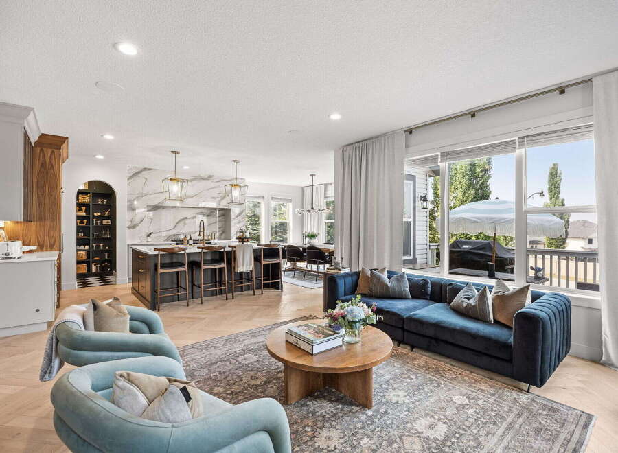 Experience modern living in this open-concept home featuring a gourmet kitchen with a marble backsplash and a spacious island perfect for entertaining.