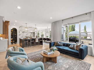 Experience modern living in this open-concept home featuring a gourmet kitchen with a marble backsplash and a spacious island perfect for entertaining.
