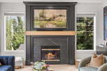 Experience cozy evenings by this stunning fireplace, featuring a dark marble surround and a beautiful landscape painting above.
