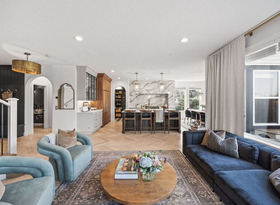 Experience modern living in this spacious open-concept home, featuring a gourmet kitchen with a marble island and sleek cabinetry.