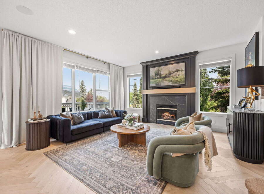 Experience luxury living in this stunning living room, featuring a modern sectional sofa and plush armchairs perfect for relaxation.