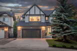 This stunning two-story home features a modern exterior with stone accents and a spacious double garage.