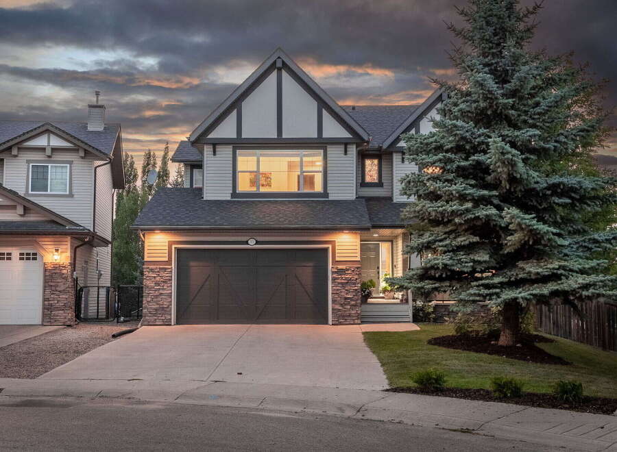 This stunning two-story home features a modern exterior with stone accents and a prominent gable roofline.