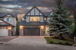 This stunning two-story home features a modern exterior with stone accents and a prominent gable roofline.