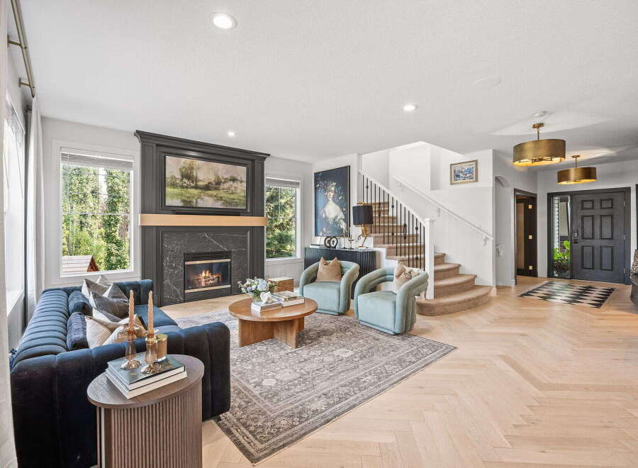 Step into this inviting living room, featuring a cozy fireplace and plush navy sofa perfect for relaxation.