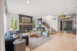 Step into this inviting living room, featuring a cozy fireplace and plush navy sofa perfect for relaxation.