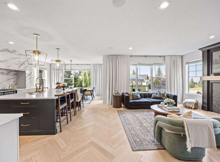 Experience modern luxury in this open-concept living space, featuring a gourmet kitchen with a marble backsplash and a spacious island perfect for entertaining.