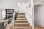 Step into luxury with this stunning home featuring a grand staircase and a cozy living area.
