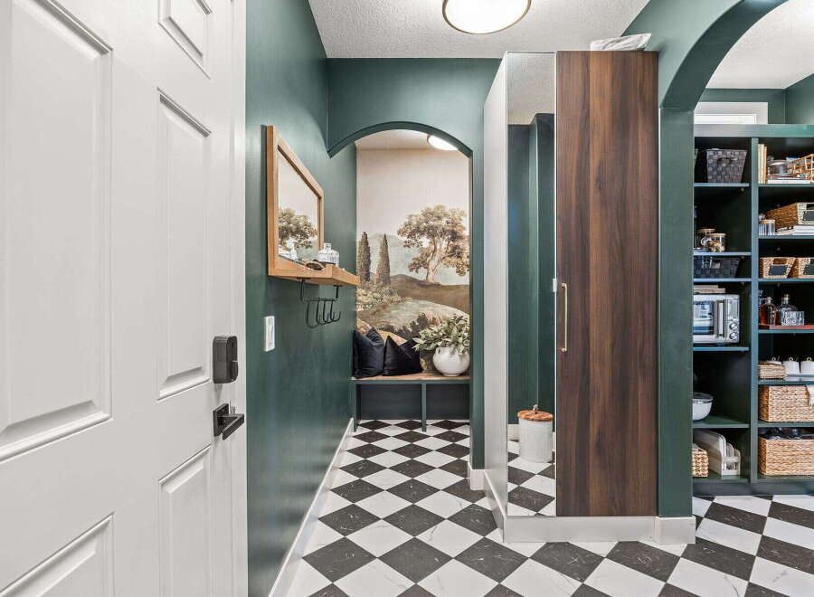 Step into this charming entryway featuring a striking black and white checkered floor that adds a bold statement.