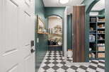 Step into this charming entryway featuring a striking black and white checkered floor that adds a bold statement.