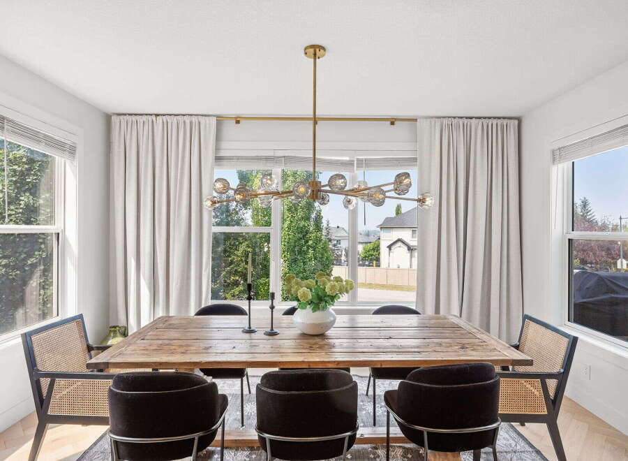 Experience elegant dining in this beautifully appointed space, featuring a rustic wooden table perfect for gatherings.