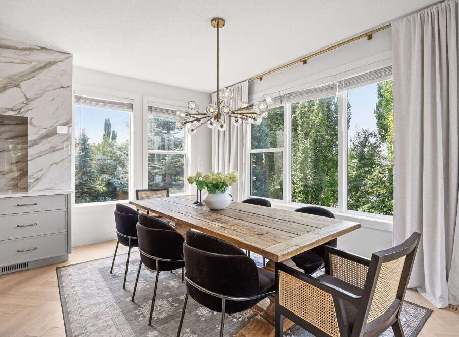 Experience elegant dining in this beautifully appointed space, featuring a rustic wooden table surrounded by plush chairs.