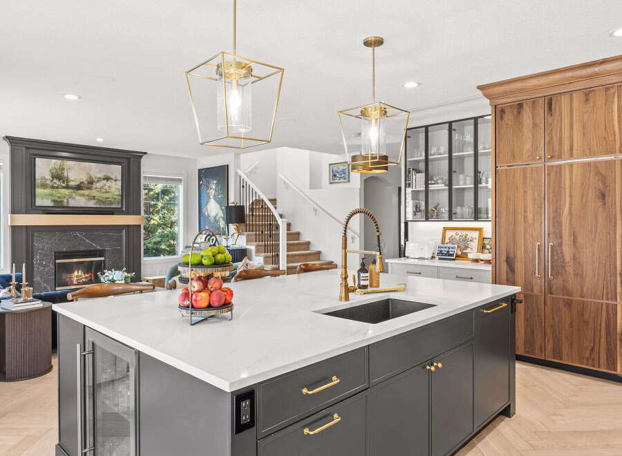 Experience luxury living in this stunning kitchen, featuring a spacious island with a modern sink and elegant brass faucet.