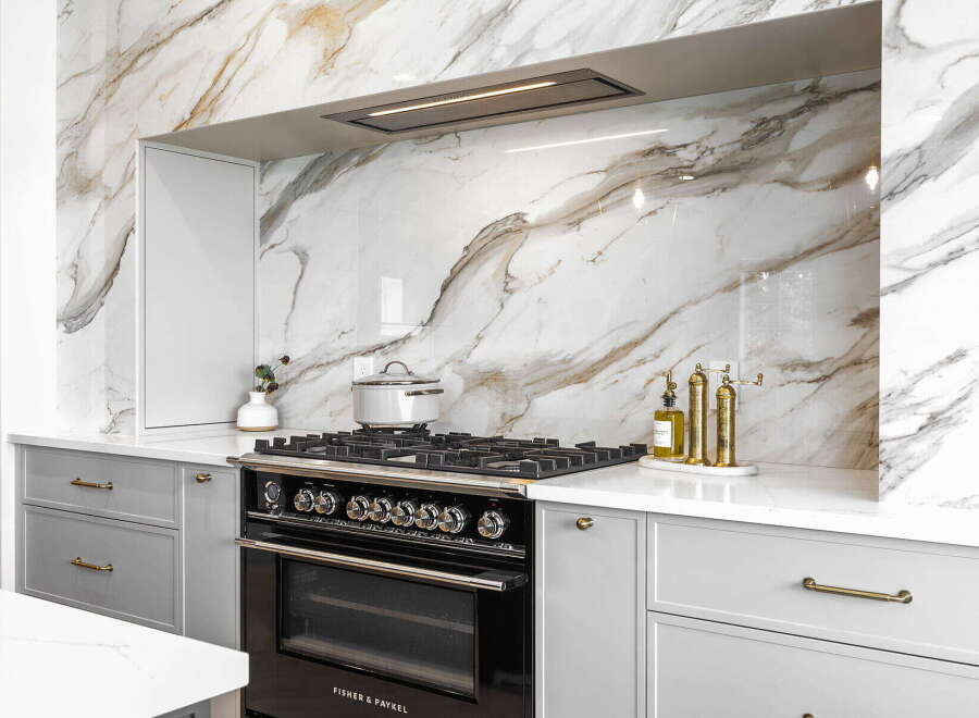 Experience luxury in this modern kitchen, featuring a stunning marble backsplash that adds a touch of elegance.