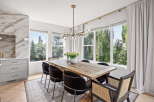 Experience elegant dining in this beautifully appointed space, featuring a rustic wooden table surrounded by plush chairs.