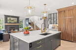 Experience luxury living in this stunning kitchen, featuring a spacious island with a modern sink and elegant brass faucet.