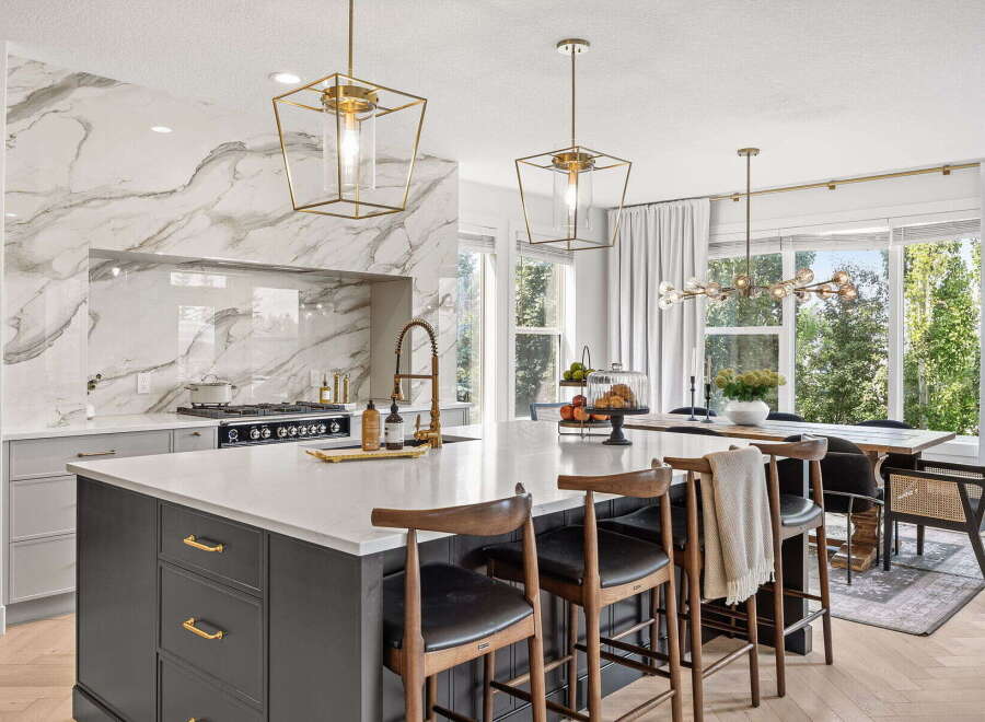 Experience luxury in this stunning modern kitchen, featuring a dramatic marble backsplash and a spacious island perfect for entertaining.